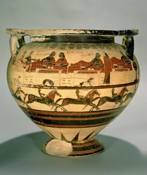 Cratera de colunas coríntia antiga de figuras negras representando Héracles a jantar com Eurítio e os seus filhos, servido por Iole, sobre uma fila de cavaleiros, de Cerveteri, c. 600 a.C.